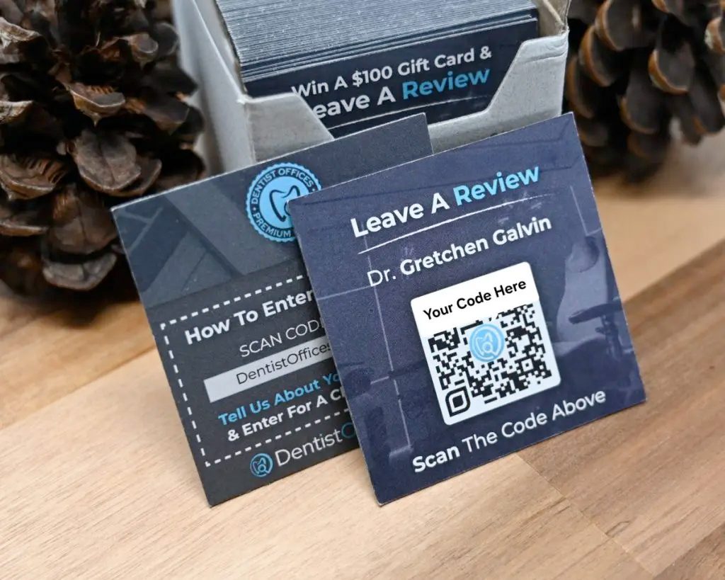 Image of review building cards sitting on a wooden surface with pine cones in the background.